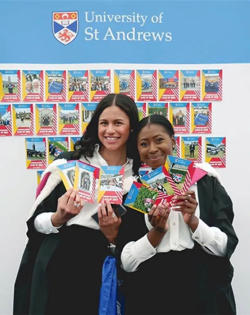 St Andrews graduates holding SquareShare prints