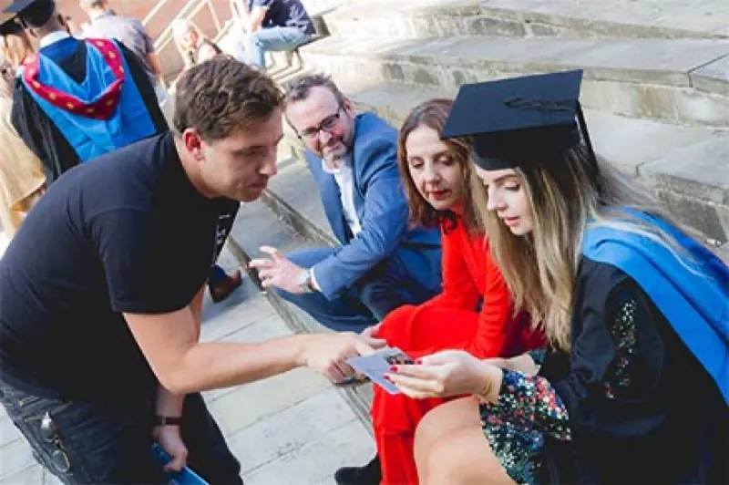 Showing a graduate their SquareShare print