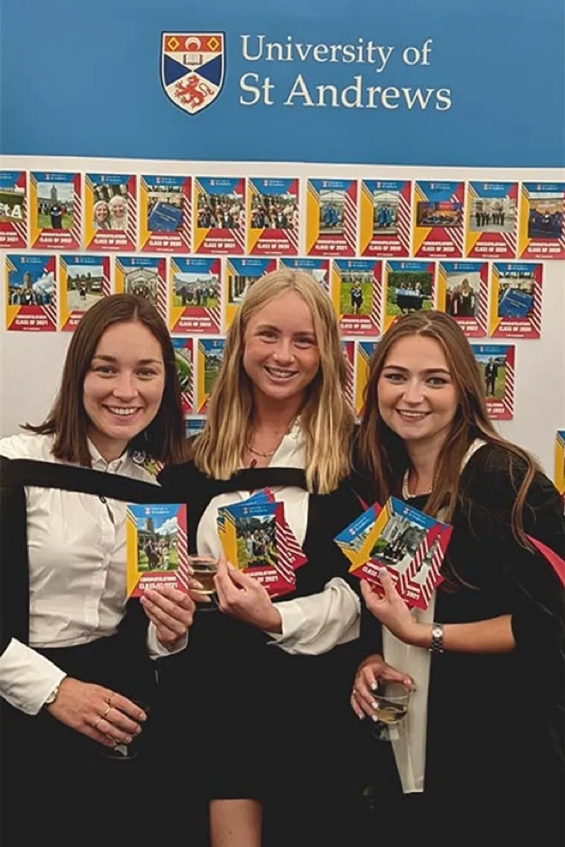 Three St Andrews graduates with their prints
