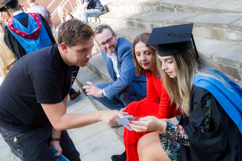 SquareShare team showing prints on the steps