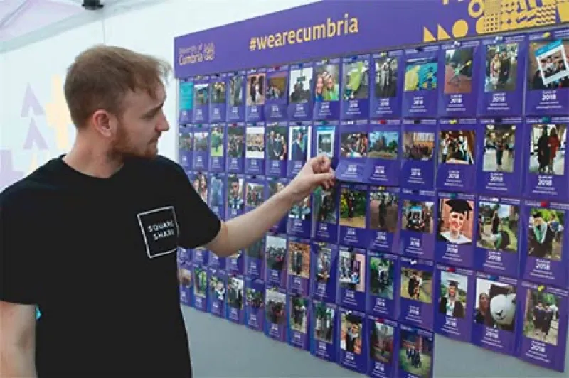 SquareShare team member with the Cumbria photo wall